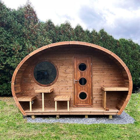 Saunalife outdoor Hobhouse barrel sauna with a changing room in a backyard setting